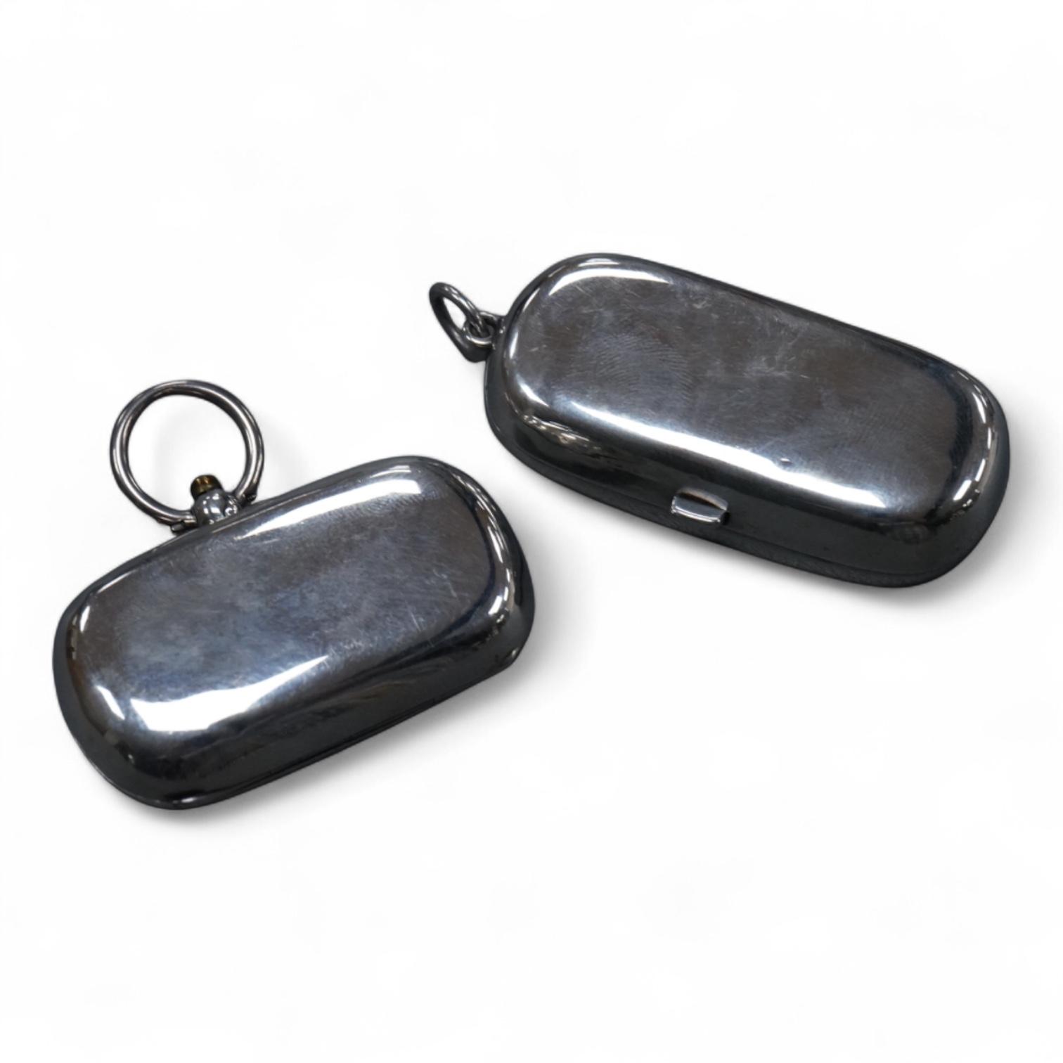 Two Edwardian twin compartment silver sovereign cases, one for sovereigns, the other for sovereign and half sovereign, both Birmingham, 1909, largest 56mm.